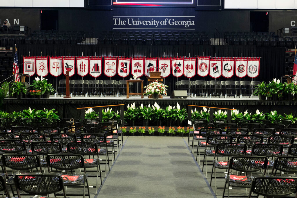 All 18 gonfalons hanging up on the stage behind the podium at graduation.